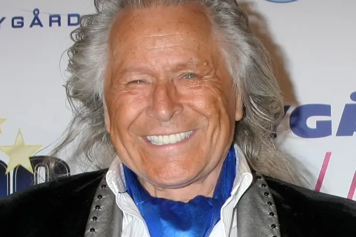 Peter Nygard smiles for paparazzi on the red carpet at an Oscar watching party in Beverly Hills in 2015.